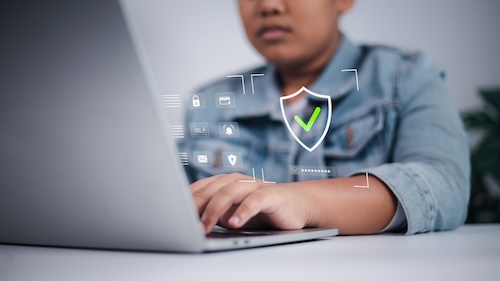 Student in front of laptop with Security check
